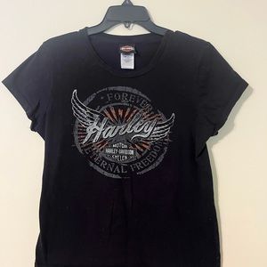 Women’s Harley Davidson Shirt with distressed appearing logo on front.